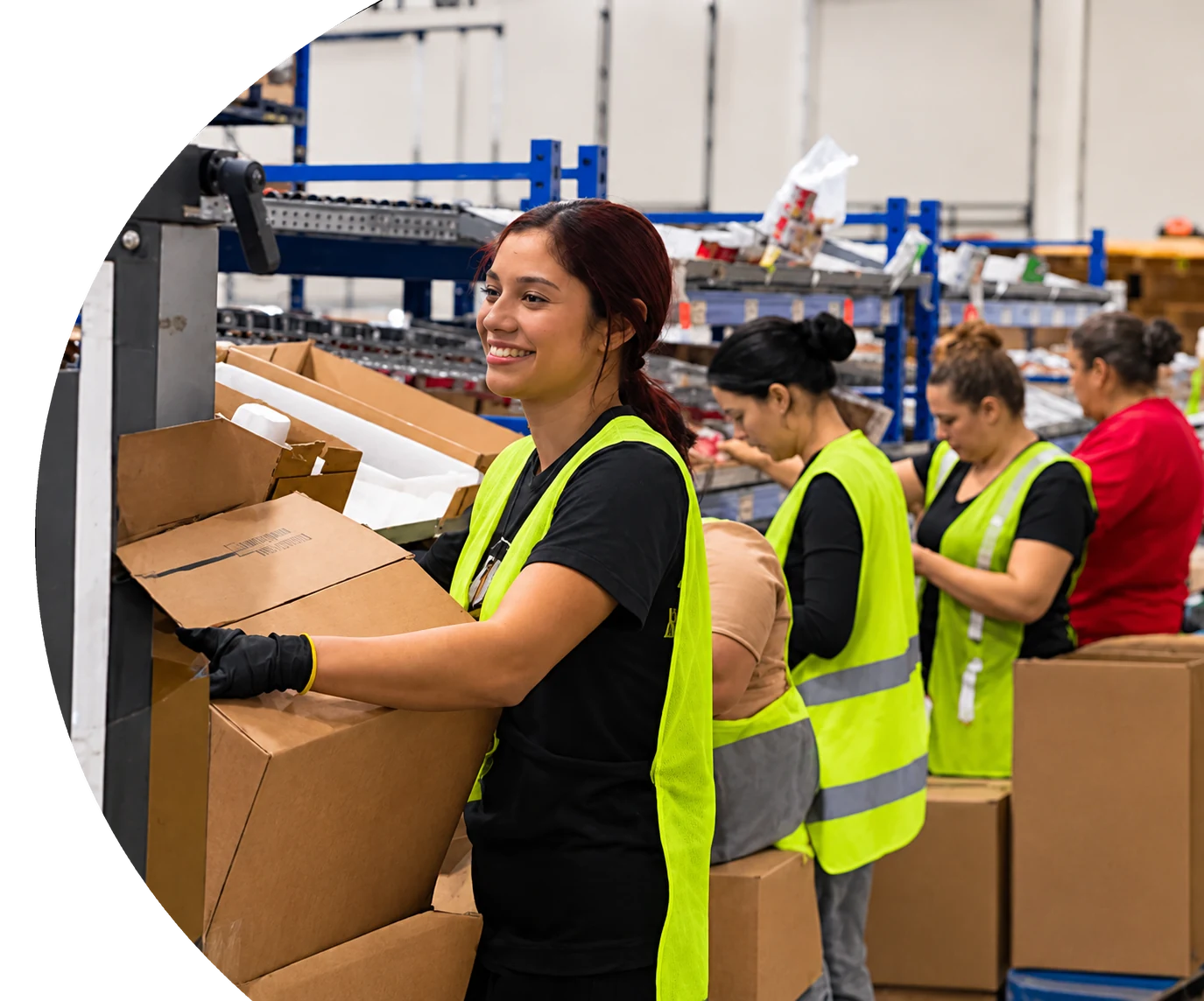 A warehouse team packing meal kit boxes